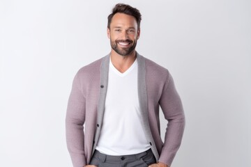 Portrait of a handsome man standing with hands in pockets isolated on a white background