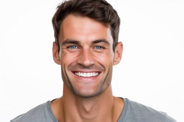 Obraz premium Close-up portrait of a handsome young man smiling on white background