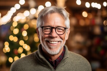 Portrait of a senior man with glasses on blurred christmas background
