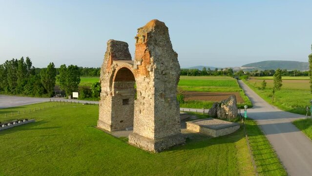 The Heidentor Ruins Of A Triumphal Arch Of The Roman Empire In Carnuntum, Austria - aerial drone shot