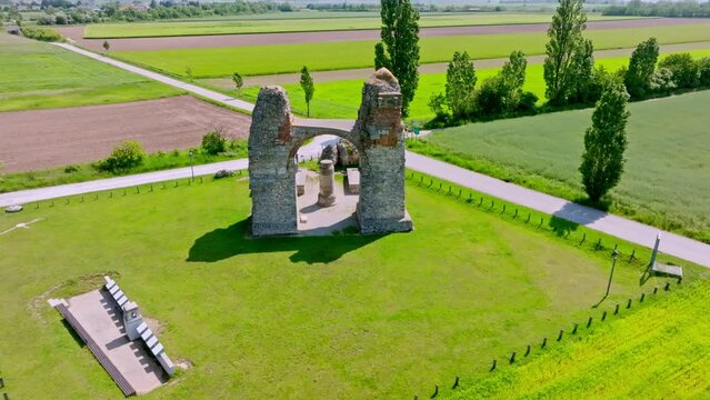 Breathtaking View Of The Remaining Arch Of Heidentor On A Sunny Day In Carnuntum, Austria. aerial