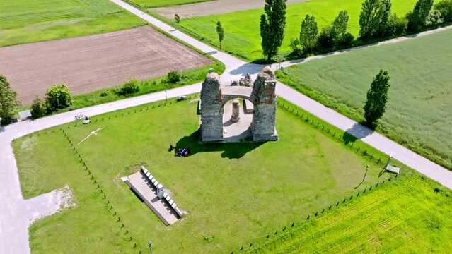 Aerial View Of Old Roman City Gate (Heidentor) At Carnuntum Archeological Site, Austria - drone shot