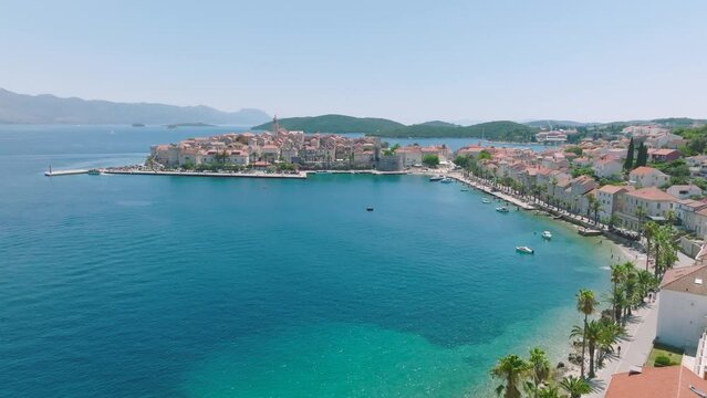 Forward aerial along waterfront of Korcula town on Croatian island