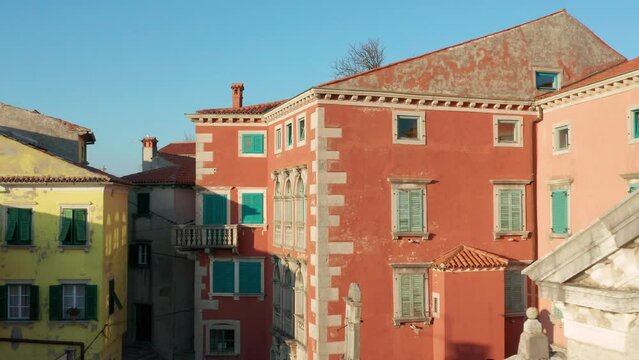 Slow aerial pull-out of old buildings in Labin town on hill in Croatia