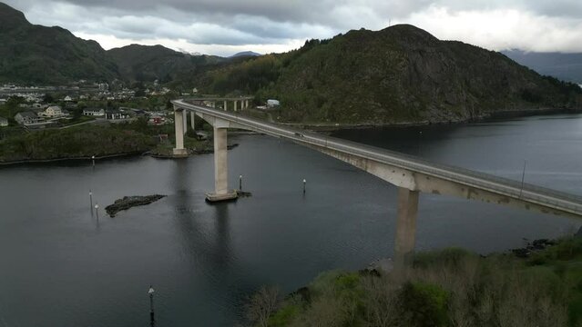 Aerial Of Bridge with Car Passing By in M&aring;l&oslash;y, Norway; M&aring;l&oslash;ybrua. Bridge connecting the former Municipality V&aring;gs&oslash;y to the rest of the Country. Drone video upwards and forwards motion.