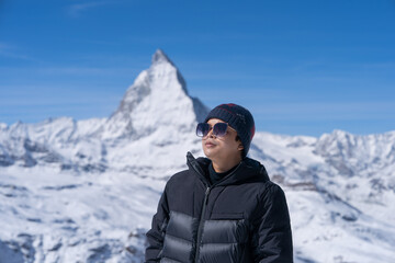 Fototapeta na wymiar Man with Matterhorn mountain in the Morning. Zermatt, Switzerland.