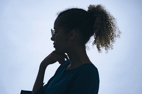 Profile Silhouette Of Thinking Black Woman In Studio Shot.