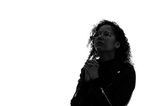 Profile Silhouette Of Praying Black Woman In Studio Shot.