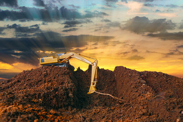 Crawler excavator is digging soil in the construction site  with of sunset  backgrounds.