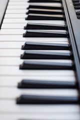 Fototapeta premium Close-up of piano keys. Piano black and white keys and Piano keyboard musical instrument placed at the home balcony during sunny day.