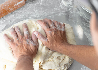 Fototapeta premium man kneading dough