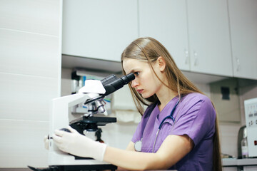 A girl veterinarian examines a dog