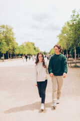 couple walking in a tree lined promenade in europe