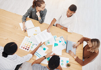 Diversity, top view of colleagues planning and brainstorming together with paperwork on a table at...