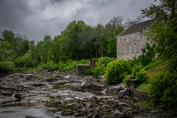 An old mill from pioneer days sits crumbling by a river in the ghost town of Balaclava, Ontario.