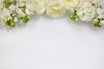 Obraz na płótnie Canvas White Bridal Floral Border of wild roses and small flowers on white background 