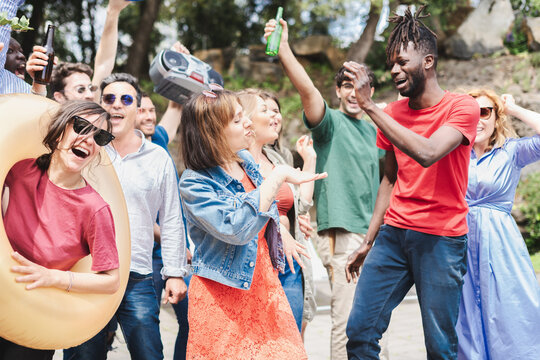 A group of joyfully people dancing and letting loose at a pool party
