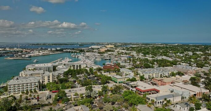 Key West Florida Aerial v10 flyover Duval St and Sunset Pier capturing summer coastal town, waterfront resorts, Mallory Square and yacht sailing on the water - Shot with Mavic 3 Cine - April 2022