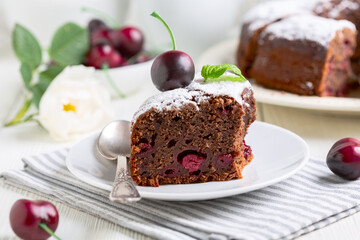 Piece of chocolate pie with cherries.
