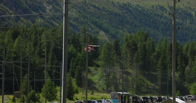 Swiss Air-Rescue helicopter taking off over busy road, Switzerland. Low angle and slow-motion