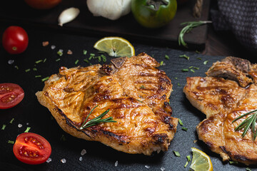 Grilled beef steak with spices on a stone background