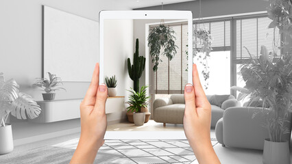 Hands holding tablet showing minimal living room, total blank project background, augmented reality...