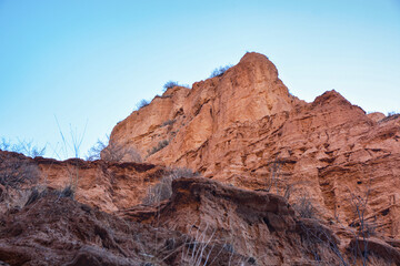 Fototapeta na wymiar Beautiful view of cliffs from yellow red limestone. Kyrgyzstan.