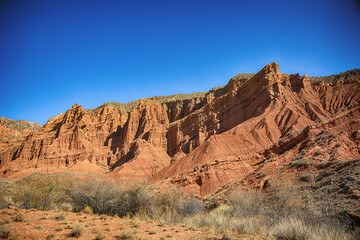 Beautiful view of cliffs from yellow red limestone. Kyrgyzstan.