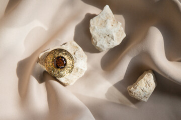 Gold brooch with ruby, modern still life.