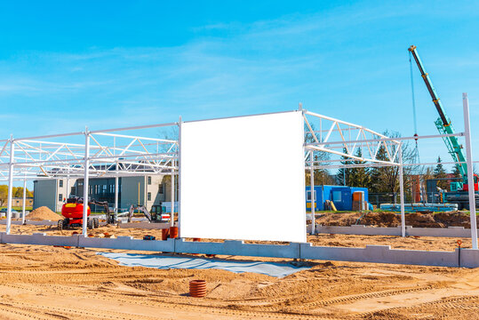 Construction Site With Crane And Empty Advertising Billboard In Foreground.Blue Sky,summer Hot Day.