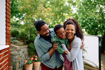 Cheerful black family has fun together in backyard.