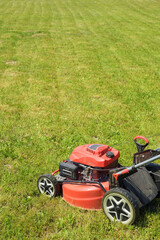 Obraz premium Lawn mower on cut grass. Mowing the grass.
