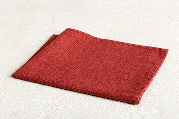top view with red empty kitchen napkin isolated on table background. Folded cloth for mockup with...