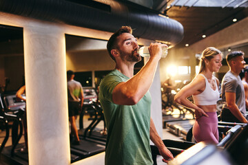 Man drinking water after working out