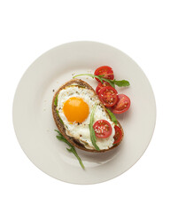 Toasts with egg, avocado and other vegetables on a gray background in a plate. healthy breakfast