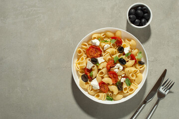 Pasta salad with dried tomatoes, cheese and olives