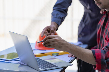 Structural engineer and foreman worker with touchpad talking Work plan for outdoor building...