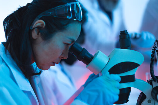 scientist performs analysis in the laboratory using the electron microscope - Powered by Adobe