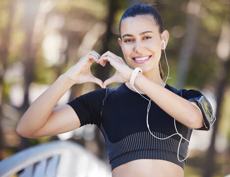 Runner, heart hands or portrait of happy woman in park for running exercise or workout for body health. Love sign, hand gesture or active girl athlete runner in sports training for fitness in nature
