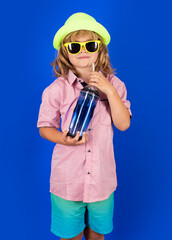 Kid drinking fresh water, isolated on studio background. Child holds glass of clear water. Healthy lifestyle, health care. Portrait of kid drinking water.