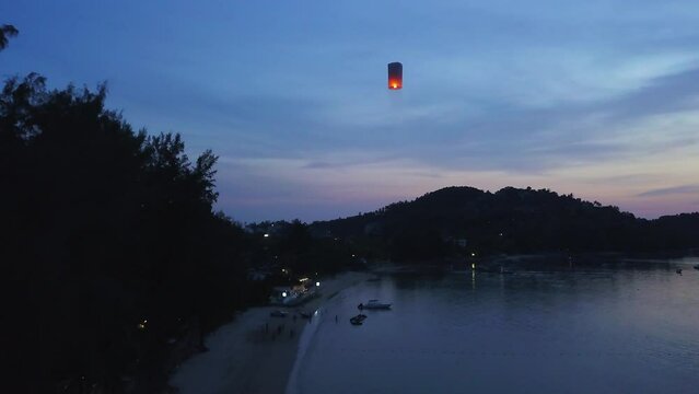 Aerial cinematic drone pattern festival sunset Phuket Koh Phi Phi Islands Thailand May Bay Lagoon Krabi Samui stunning aqua deep blue water resort people the Beach slowly forward up movement