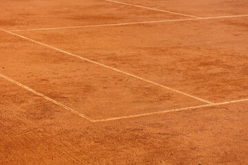 tennis court made of red clay soil with markings for game or competition. sports and recreation, professional performance champions in lawn tennis with rackets and balls. training of athletes outdoor