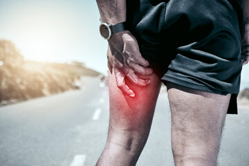 Fitness, hamstring and injury with a sports man holding his muscle in pain while outdoor for a...