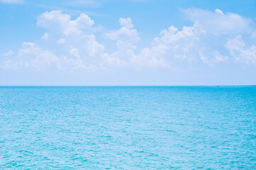 Obraz premium Sea or ocean calm water with blue sky and white clouds.