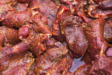Obraz na płótnie Canvas Pieces of juicy, fresh beef in spices, close-up. Beef raw steaks, top view.