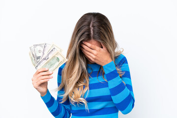 Young Uruguayan woman taking a lot of money isolated on white background with tired and sick expression