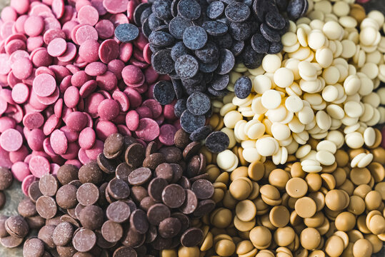 Ruby white and dark chocolate callets closeup - Tempered chocolate confectionery. High quality photo