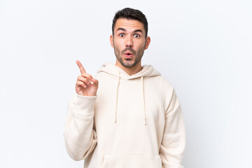 Young caucasian man isolated on white background intending to realizes the solution while lifting a finger up