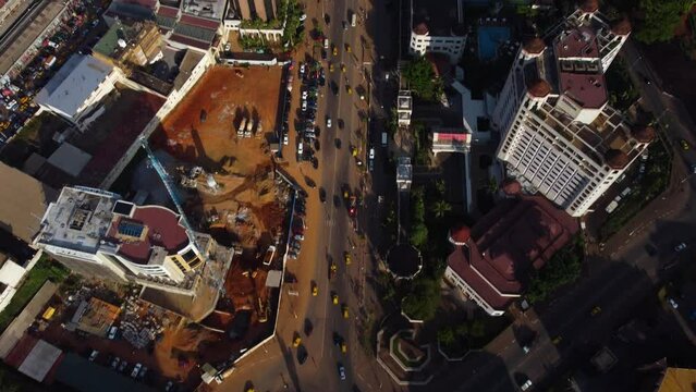 Aerial tilting overview of downtown Yaounde city, golden hour in Cameroon, Africa