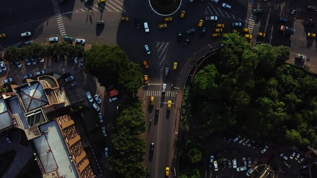 Aerial top down, chaotic traffic driving around roundabout in Yaound&eacute;